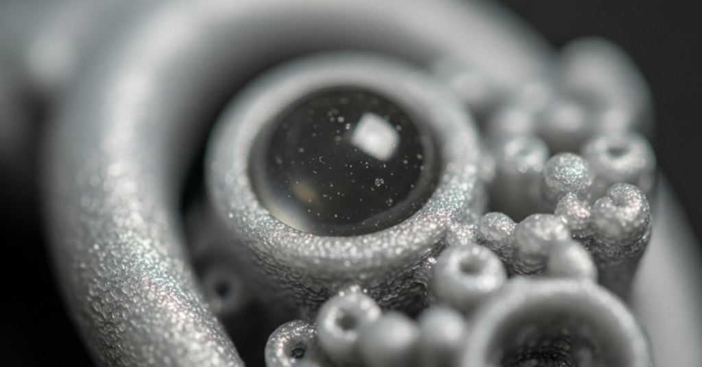Macro close-up of a resin 3D printed object showing fine surface texture, smooth curves, and intricate details