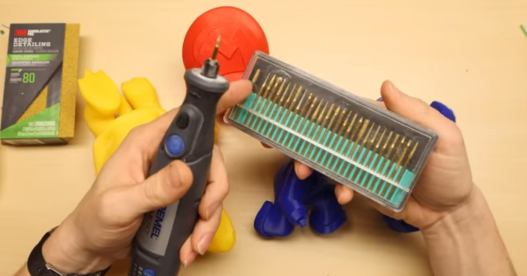 Hand holding a rotary tool with precision bits for sanding and smoothing 3D printed parts, essential for post-processing and achieving flawless finishes.
